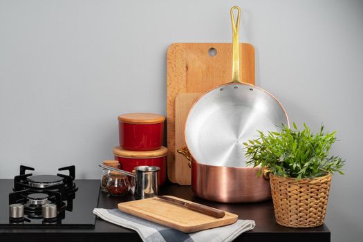 Kitchen counter with copper pots, gas stove and kitchen utensils