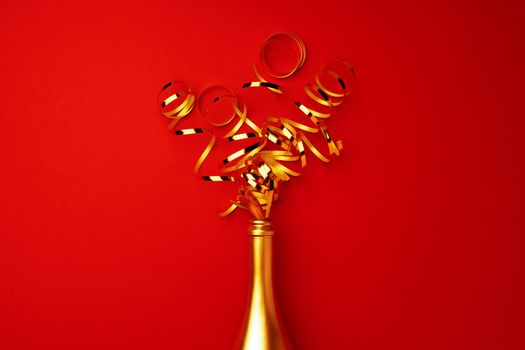 Champagne bottle with streamers flat lay top view, Christmas background