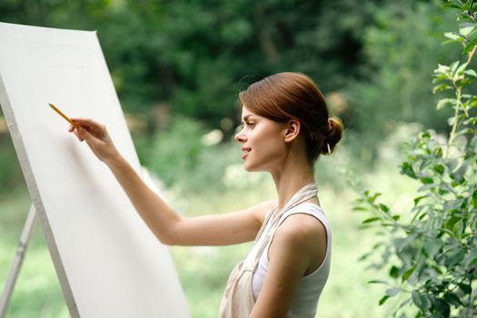 woman artist nature easel drawing creative landscape. High quality photo