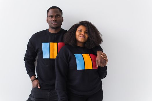 Happy African American woman and man have relationships, toothy smile, happy to meet with friends, dressed casually on white background. Emotions and friendship