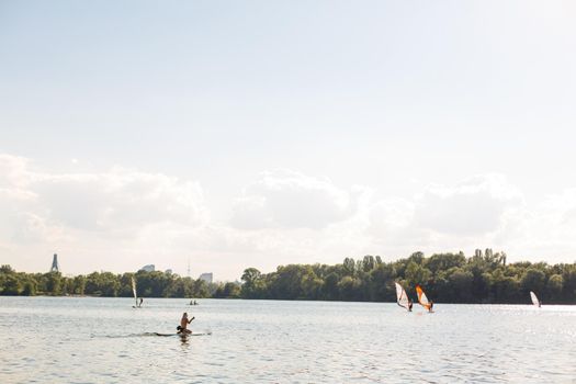 Young attractive woman on stand up paddle board in the lake, SUP