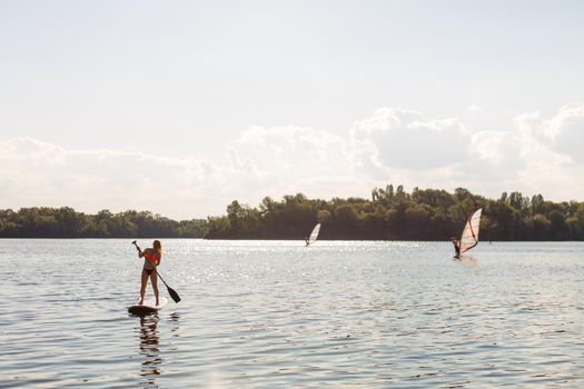 Action Shot of Young Woman on Paddle Board