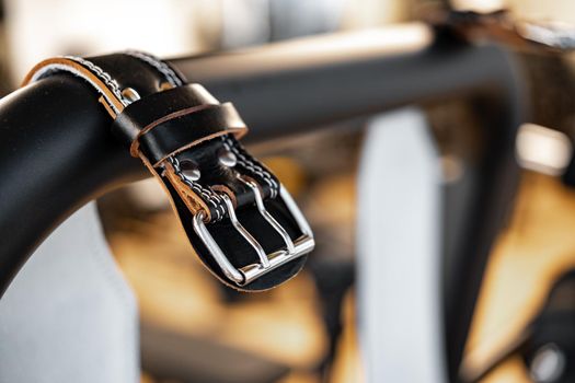 Weight belt hanging on a gym apparatus in a fitness hall, close up