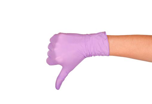 Hand showing thumbs down sign against white background. Hand in a purple latex glove isolated on white. Woman's hand gesture or sign isolated on white. Rejection symbol