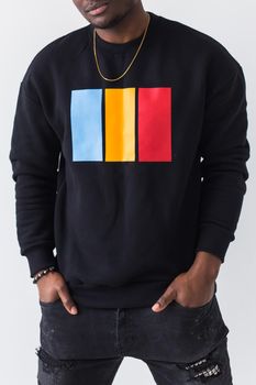 Studio shot of young handsome African man wearing hoodie against white background.