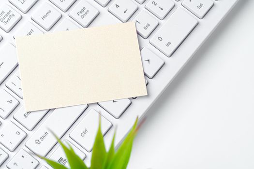 Blank business cards with supplies and keyboard on office table. Close up.