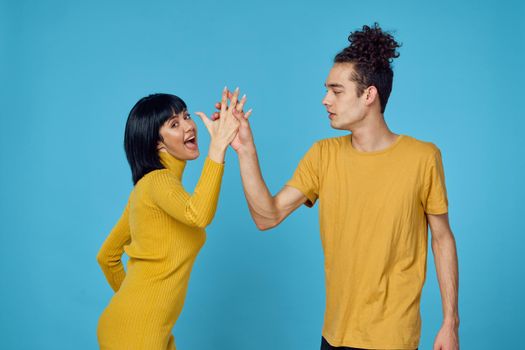 kinky guy and girl together friendship fun blue background. High quality photo