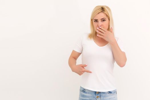 woman shows a spot on her white t-shirt