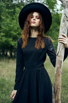 woman in witch costume fantasy magic forest posing. High quality photo