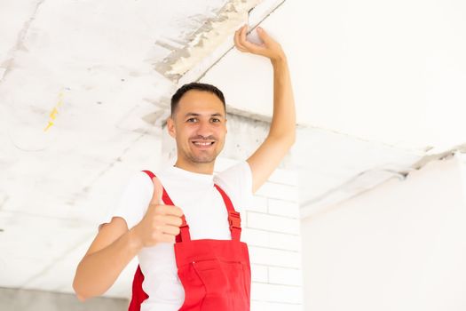 Young man fixing ceiling insulated. Renovation, construction