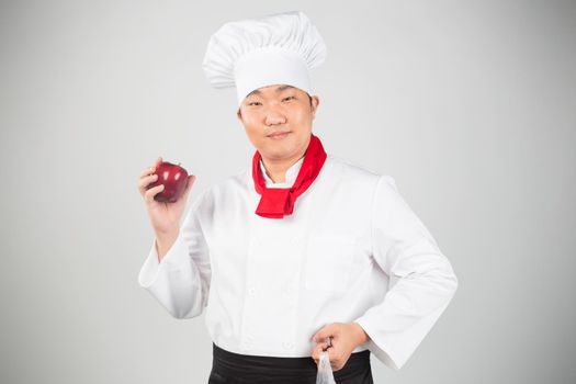 man in chef's hat with fruits on a white background