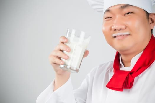 chef holding glass cup and drink yogurt or milk nice photo