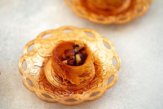 Turkish baklava and Turkish tea in oriental dishes on gray background, close up