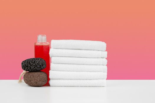Spa still life with stacked towels and spa stone, front view