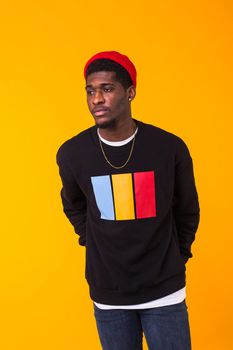 Handsome African American man posing in black hoodie on a white background. Youth street fashion photo with afro hairstyle