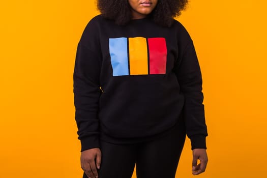 Young beautiful african american girl with an afro hairstyle. Portrait on white background. Girl looking at camera