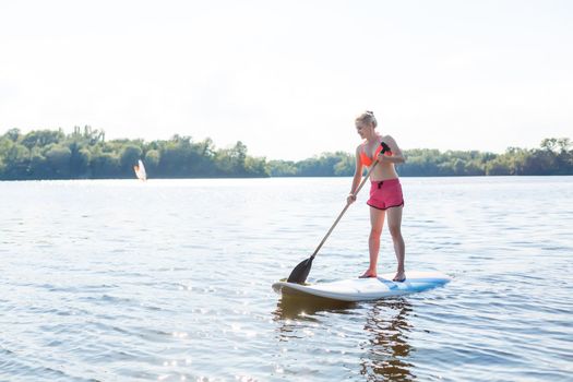 A beautiful woman practicing paddle on a beautiful sunny day