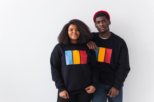 Happy African American woman and man have relationships, toothy smile, happy to meet with friends, dressed casually on white background. Emotions and friendship