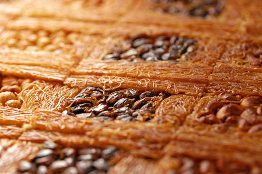 Close up photo of Turkish Baklava dessert with honey and nuts