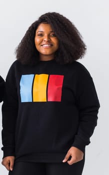 Young beautiful african american girl with an afro hairstyle. Portrait on white background. Girl looking at camera