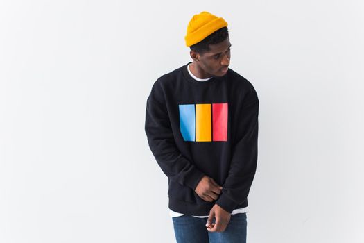 Studio shot of young handsome African man wearing hoodie against white background.