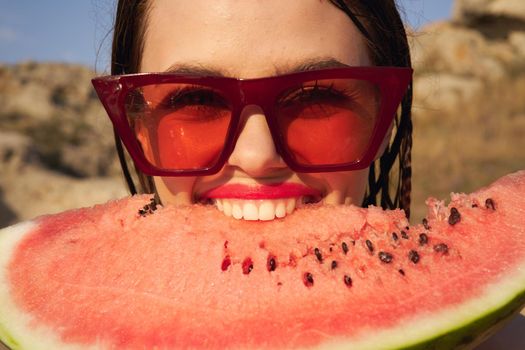 Cheerful woman eating watermelon nature summer vacation. High quality photo