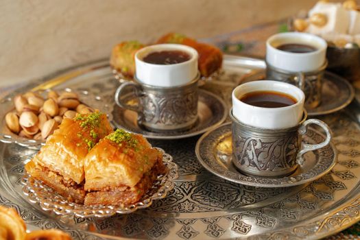 Traditional arabic dessert baklava with a cup of turkish coffee, close up