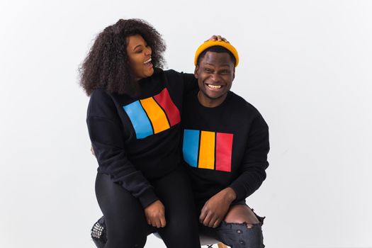 Happy African American woman and man have relationships, toothy smile, happy to meet with friends, dressed casually on white background. Emotions and friendship concept.