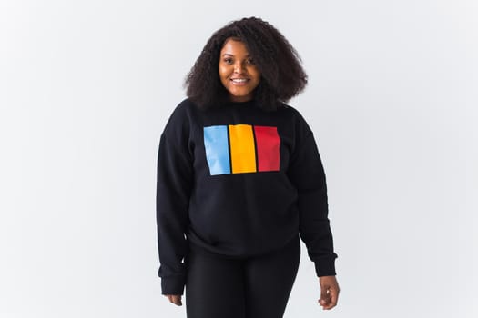 Young beautiful african american girl with an afro hairstyle. Portrait on white background. Girl looking at camera