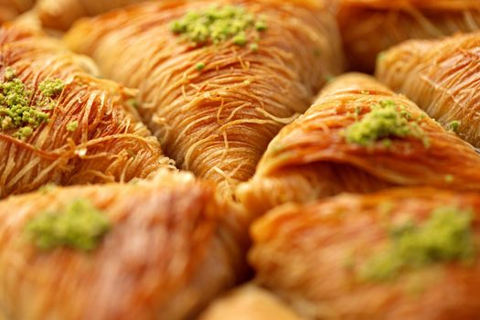 Close up photo of Turkish Baklava dessert with honey and nuts