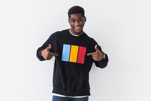 Handsome African American man posing in black hoodie on a white background. Youth street fashion photo with afro hairstyle