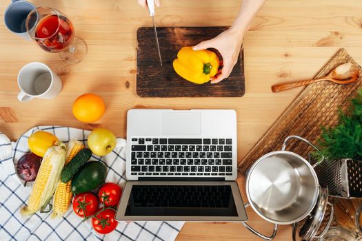 Unrecognizable woman cooking vegetables in her kitchen close up