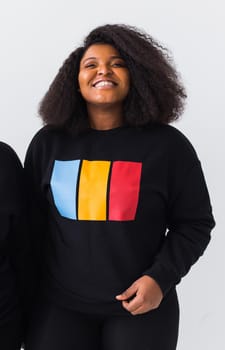 Young beautiful african american girl with an afro hairstyle. Portrait on white background. Girl looking at camera