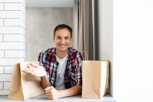 delivery man with paper containers for takeaway food.