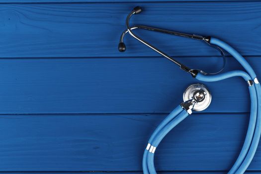 Medical stethoscope on classic blue background top view. High quality photo