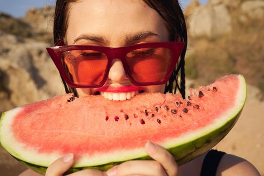 Cheerful woman eating watermelon nature summer vacation. High quality photo