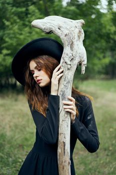 woman in witch costume halloween forest staff gothic. High quality photo