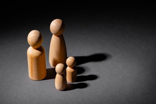 Wooden little figures of people close up. Family concept