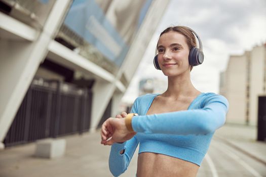 happy beautiful caucasian woman at workout in urban city