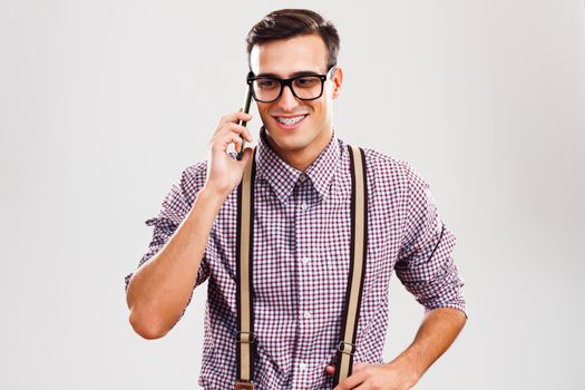 Portrait of nerdy man talking on the phone.