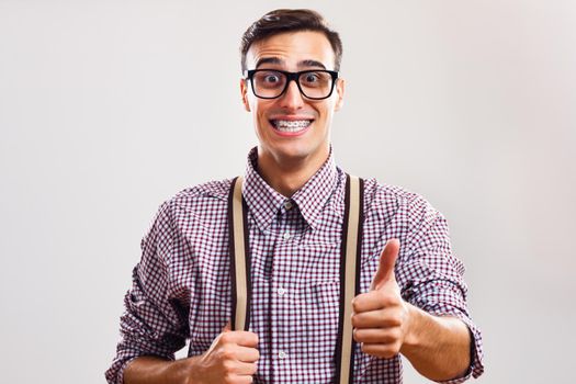 Portrait of nerdy man giving thumbs up.