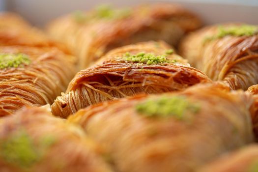 Close up photo of Turkish Baklava dessert with honey and nuts