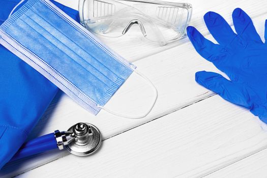 Doctors uniform with mask, stethoscope and other tools close up