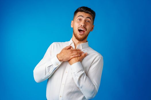 Amazed and confused bearded young man looks with astonishment, portrait .