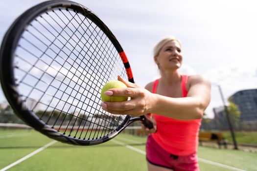 Woman playing tennis and waiting for the service