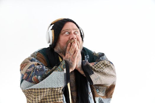 Fat stylish bearded tattoed caucasian man with big belly is posing and dancing wearing ethnic kimono