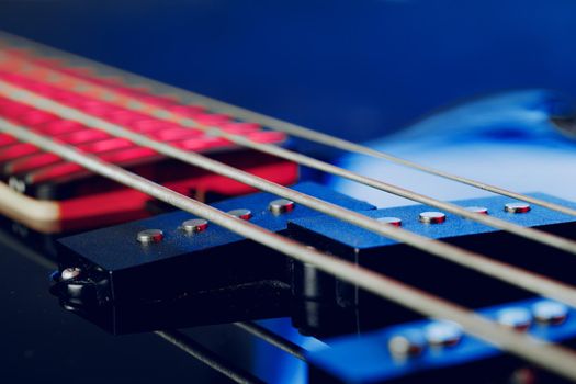 Guitar fingerboard with strings close up photo in dark