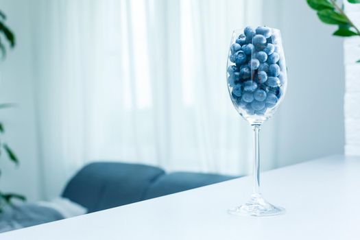 ripe blueberries in a glass goblet. Berries closeup