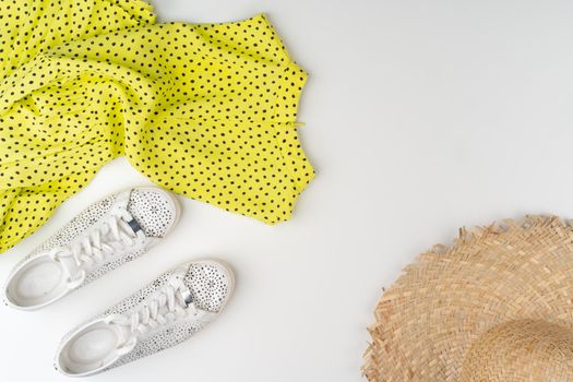 Flat lay of woman summer outfit on white background. Close up.