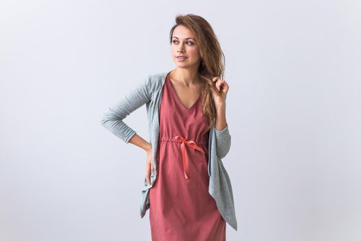 Beautiful young woman smiling against white background. Comfortable homewear, home relaxation and female fashion.